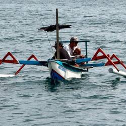 The local guys were fishing late. Some from a sanpan, others wading, and 2snorkeling to fish