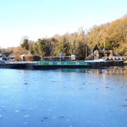 Rainboat moored against the lock wall. Lovely to see Ice Stars formed by water seeping up.