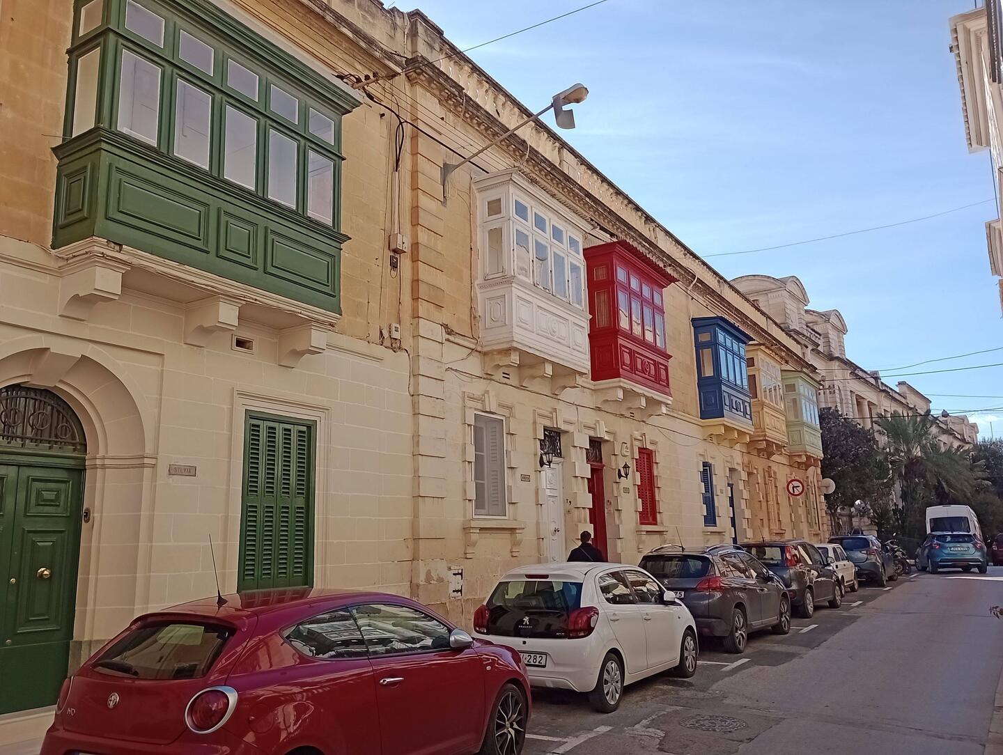 Enclosed balconies evolved under Knights of St. John for status, now a protected cultural symbol