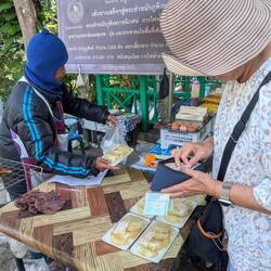 Oma was much happier giving her coins to the fruit sellers than the monks