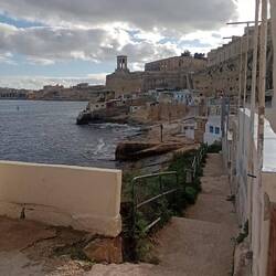 Fishing huts below the city walls, Siege Bell Monument in the background