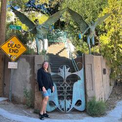Rosanne posing in front of a resident's gate