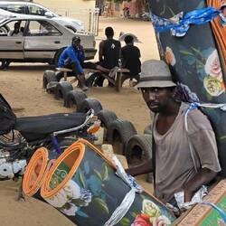 So we quickly left the brown muddy river to go watch the carpet man was carrying his carpets to town