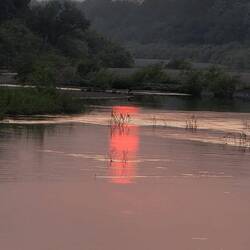 The sun sets over the sleepy Gambia river