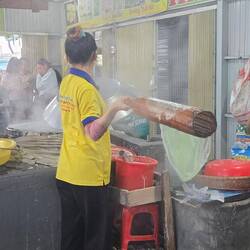 The making of rice noodles, on a barge factory on the river