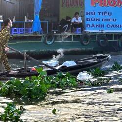 Steam rises from her cooking pot as she navigates