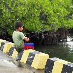 Little guy fishing on the wharf
