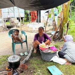 This lady cooks and sells corn. IDR 5000 for a bag of 5 ears (< 47 cents)