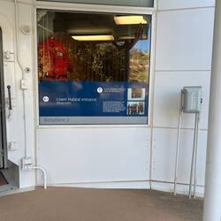 This window and phone next to the main entrance was used for face to face visits with outsiders.