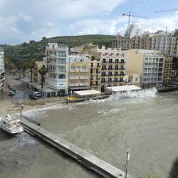 Waves hitting the sea wall, Xlendi