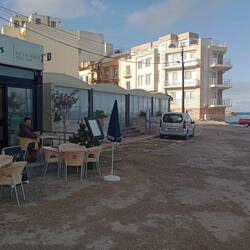 Lunch, Marsalforn. During Storm Harry, the sea inundated the land from near the red car