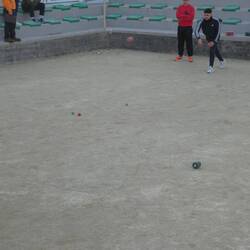 Red knocker attempting to remove the green ball (the jack is to the left of the green ball)