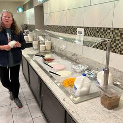 Rosanne walking past one of the food lines at LaQuinta Inn