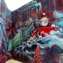 Mural depicting the train that took prisoners to Tierra del Fuego to chop down trees — Ushuaia.