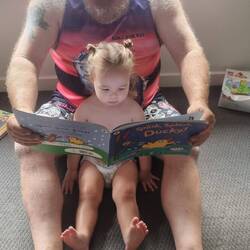 Poppy reading a book 📖 to Scottie in the morning. She loves her books 📚