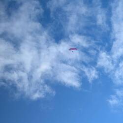 Parasailing skiing - yup - he has skiis on
