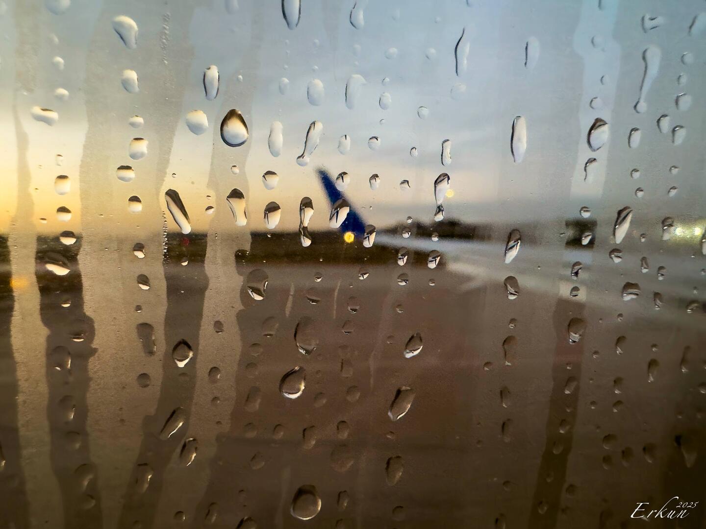 At IAH as the sun rises through the raindrops — Houston, Texas.