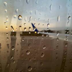 At IAH as the sun rises through the raindrops — Houston, Texas.
