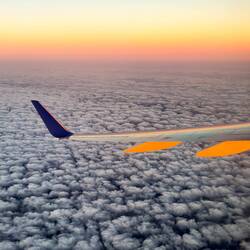 The rising sun colors the grey metal of the 757-300 that we are flying to DEN.