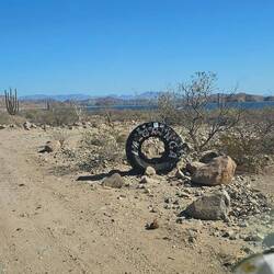 The tire marks the road to La Gringa