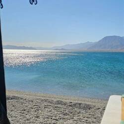 At La Gringa, we set up feet from the water. View from my van door.