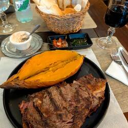 Grilled sweet potato, chimichurri, like 9 kinds of bread with chicken cheese spread, and local wine