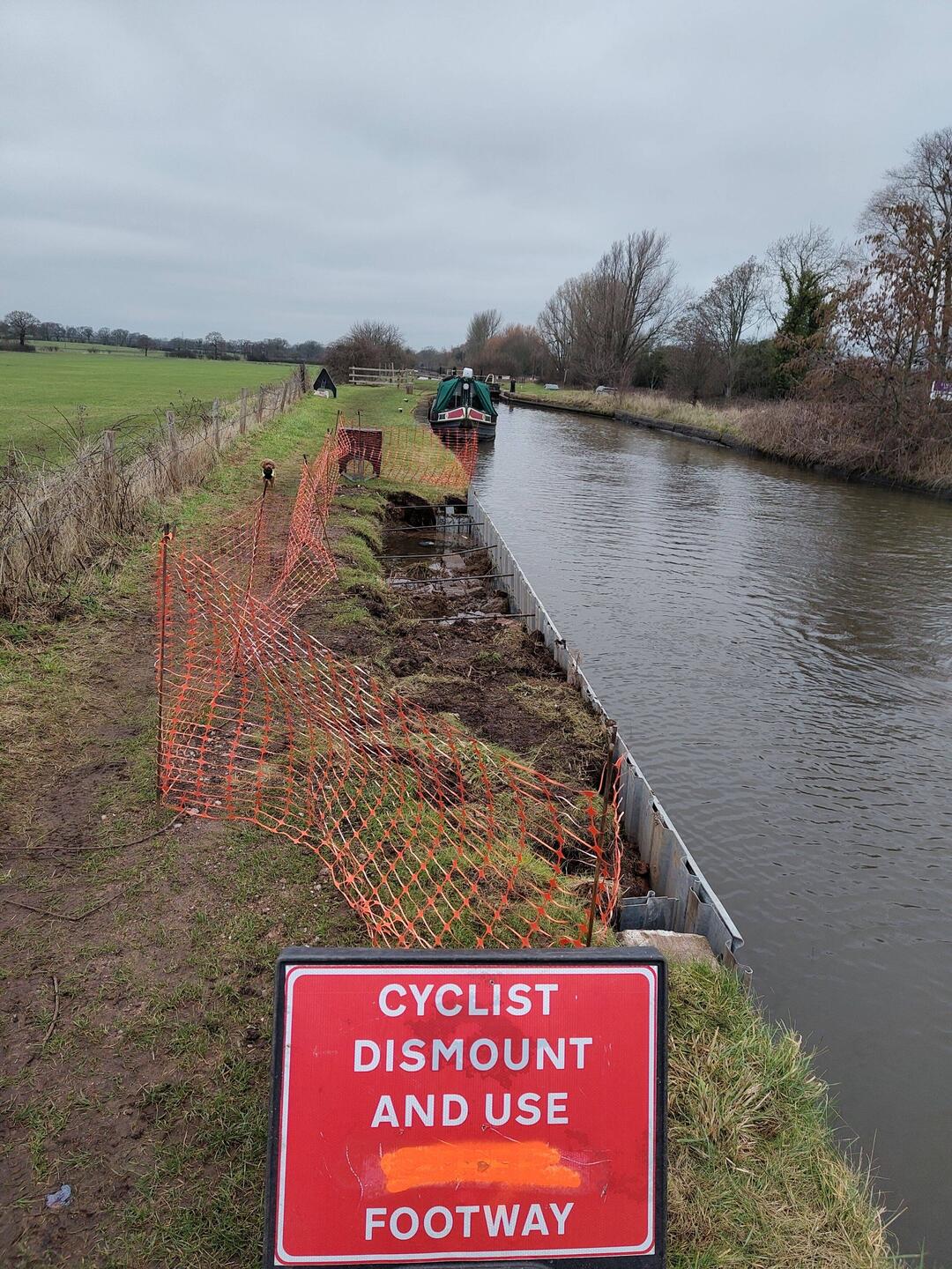 New piling being installed on a well maintained stretch of towpath