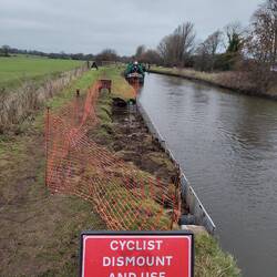 New piling being installed on a well maintained stretch of towpath
