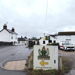 Wheelock; Cheddar Cheese (L), Pet Superstore (back R) and a sign for garden gnomes