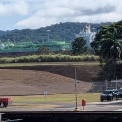 A bigger vessel passes through the new locks in the distance