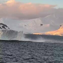 Lucky to capture this iceberg calving and turning some, and also some whales spouting lower-right