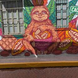 A sloth mural outside the chocolate store