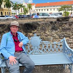 Taking his ease on a lovely plaza benc