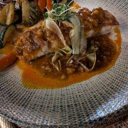 Tom's sea bass with garlic sauce and vegetables