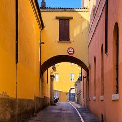 A colorful alley on our way to an apartment we want to check out — Bologna, Italy.