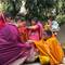 Ritual of elder giving lentils to married women family members for good luck