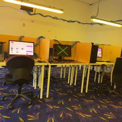 An installation set up like an internet cafe with a series of videos from You Surp.