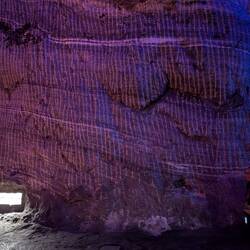 The striations are from the miner's tools (it was done by hand), the white veins are salt.