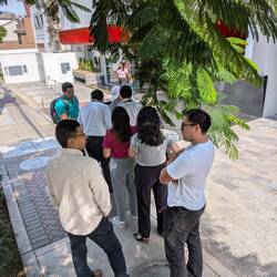 People waiting in line to buy food from a mobile street vendor. The box on the back had food.