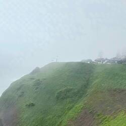 A professional paraglider is testing the wind