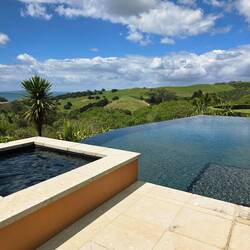 Green rolling hills, blue water in the distance