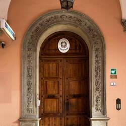 Fancy door surround at a police station — Bologna, Italy.