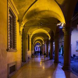A nighttime stroll under a portico — Bologna, Italy.