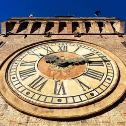 Looking up at the clock face from the lower balcony — Palazzo d'Accursio.