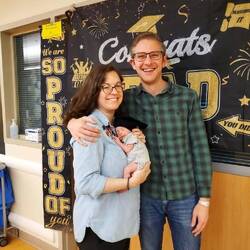Leo graduating out of the NICU with his proud and happy parents
