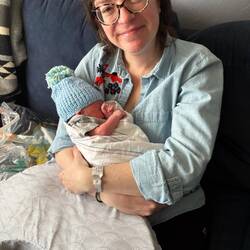 Sarah cuddling with Leo - with the hat Michelle knitted for him