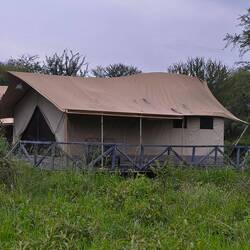 Tent hotel with shower, toilet, sink.