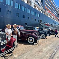 Some vintage cars showing off by the ship
