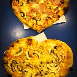 Heart-shaped pizzas at Pizzeria Nettuno — Bologna, Italy.