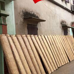 Racks of rice paper wrappings set out to dry